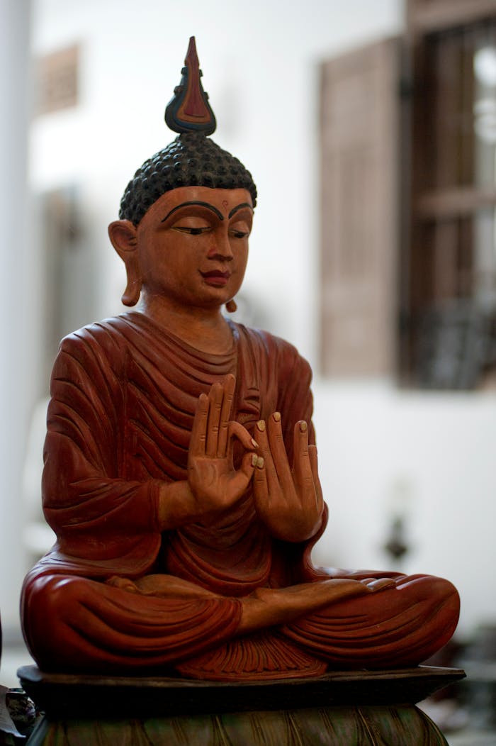 our-story A peaceful wooden Buddha statue symbolizing tranquility and spirituality indoors.